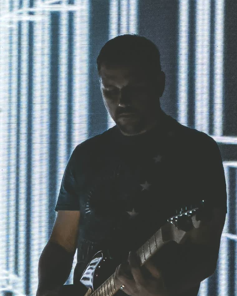 Aaron playing guitar on stage
