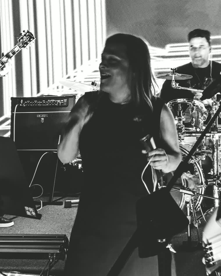 Marinet singing lead vocals on stage